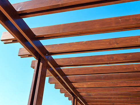Pormenor de uma pérgola de madeira pintada com Bondex.